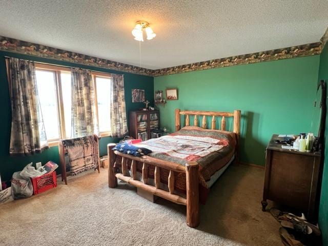 bedroom featuring carpet floors and a textured ceiling