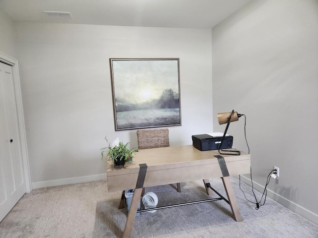 office with visible vents, baseboards, and carpet flooring
