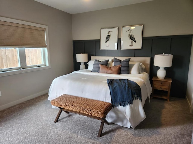 bedroom featuring carpet and baseboards