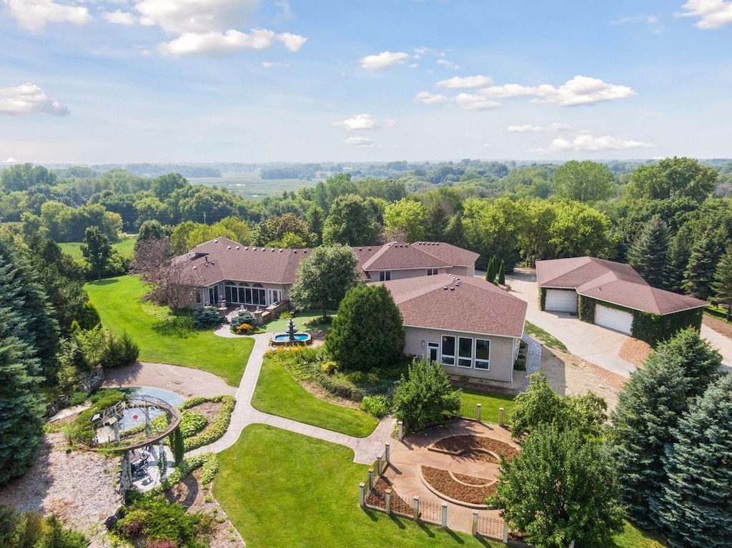 drone / aerial view featuring a forest view