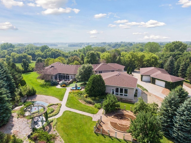 drone / aerial view featuring a forest view