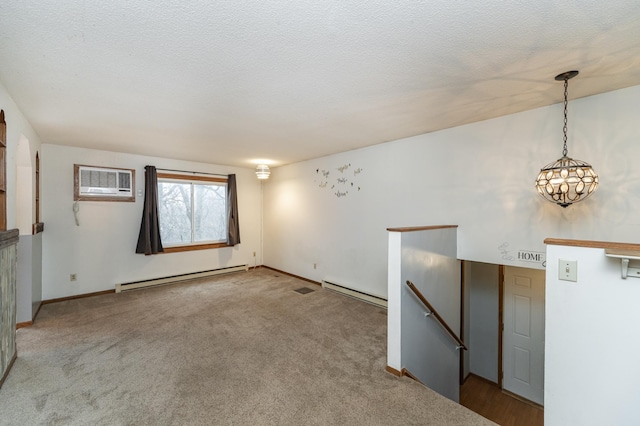 spare room with light carpet, a baseboard radiator, and a wall mounted air conditioner