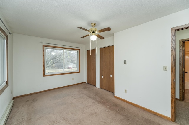 unfurnished bedroom with light carpet, a textured ceiling, and ceiling fan