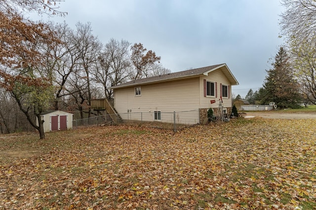 view of side of home with a shed