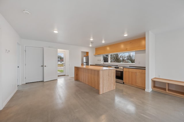 kitchen with a center island, sink, and stainless steel appliances