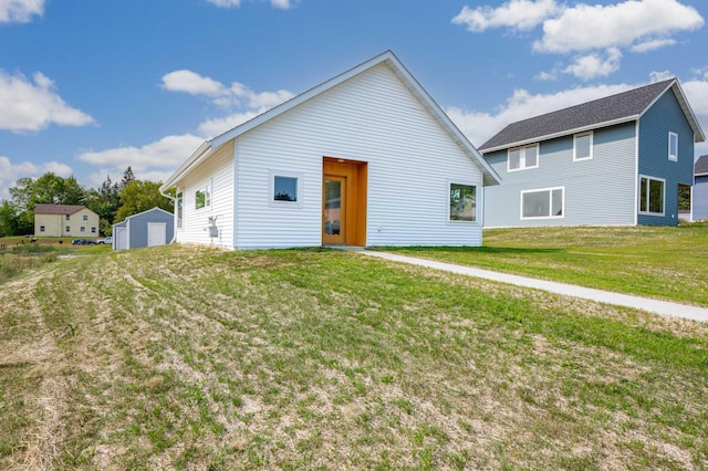 view of front of house with an outbuilding and a front yard