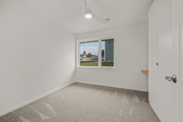 unfurnished room featuring ceiling fan and carpet floors