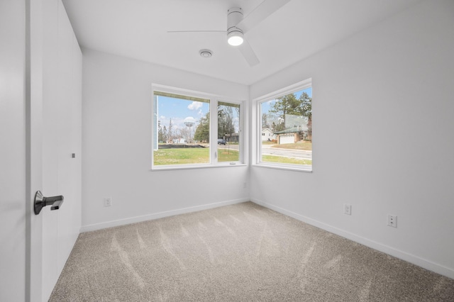 carpeted spare room with ceiling fan