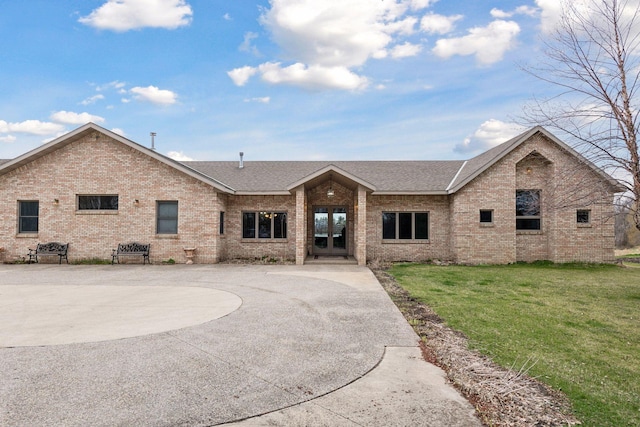 view of front facade with a patio area and a front lawn