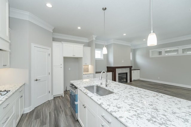 kitchen featuring pendant lighting, dark hardwood / wood-style floors, sink, and white cabinetry