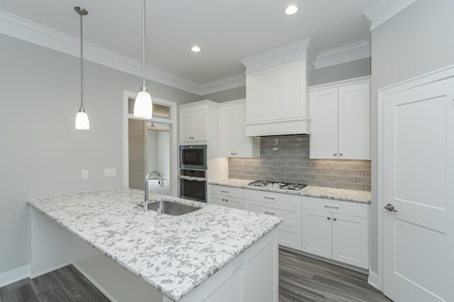 kitchen with dark wood-type flooring, sink, white cabinetry, stainless steel appliances, and decorative light fixtures