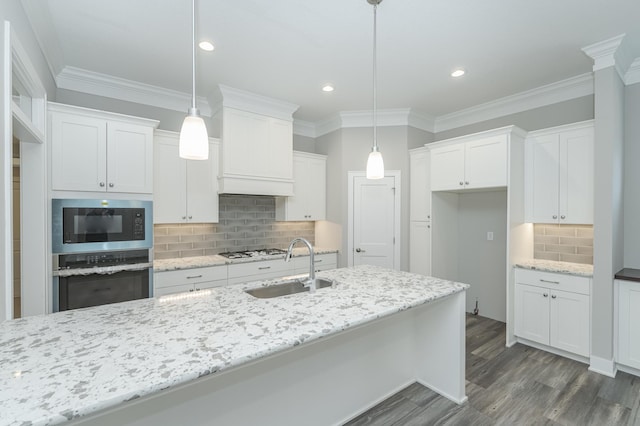 kitchen featuring white cabinetry, appliances with stainless steel finishes, and decorative light fixtures