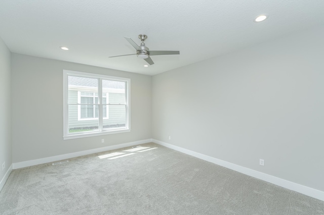 empty room with light carpet and ceiling fan