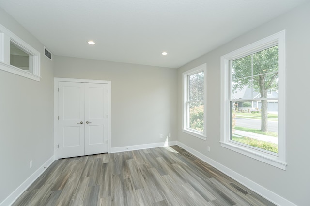 unfurnished room with light hardwood / wood-style flooring and a wealth of natural light