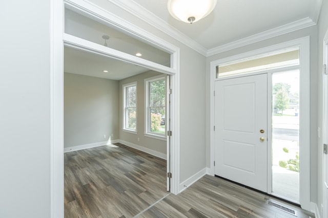 entrance foyer with ornamental molding and dark hardwood / wood-style flooring