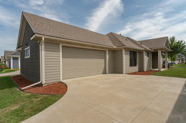 view of front of property featuring a garage and a front lawn