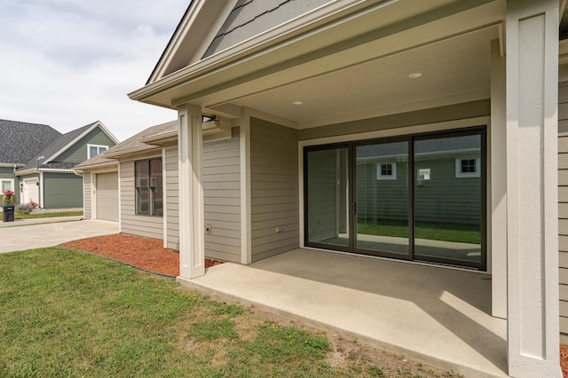 view of exterior entry with a lawn