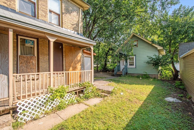 view of yard with covered porch