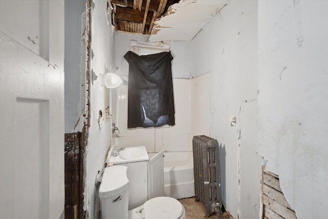 bathroom featuring a bathtub, toilet, radiator, and vanity