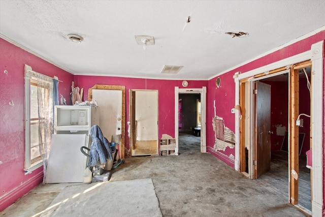 miscellaneous room featuring carpet and a textured ceiling