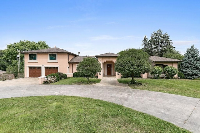 view of front facade featuring a front yard and a garage