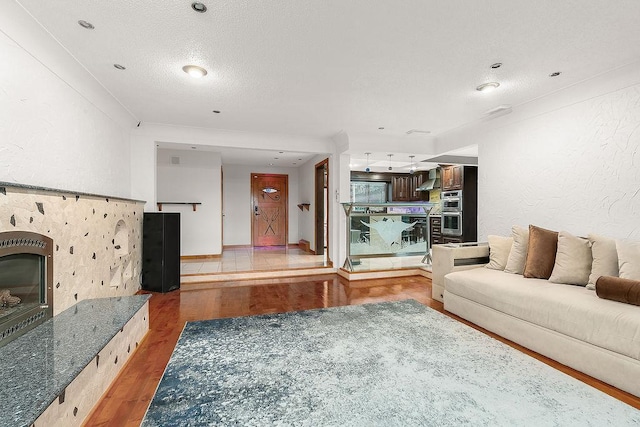 unfurnished living room featuring a textured ceiling and hardwood / wood-style flooring