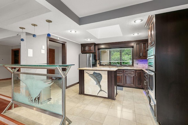 kitchen featuring stainless steel fridge, a kitchen island, dark brown cabinets, decorative light fixtures, and backsplash