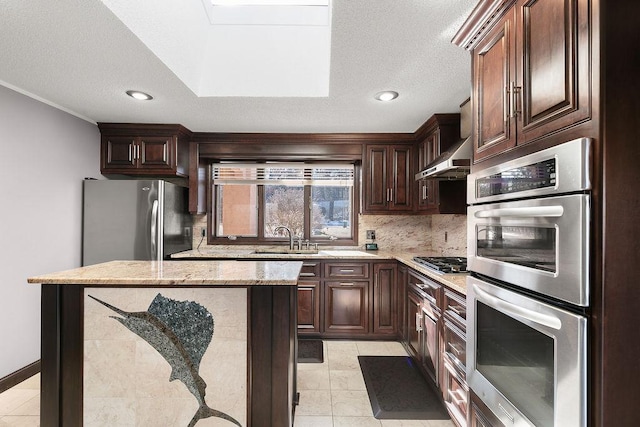 kitchen featuring light stone counters, sink, tasteful backsplash, a textured ceiling, and stainless steel appliances