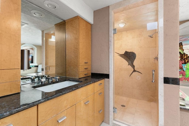 bathroom with vanity, a shower with shower door, and tile patterned floors