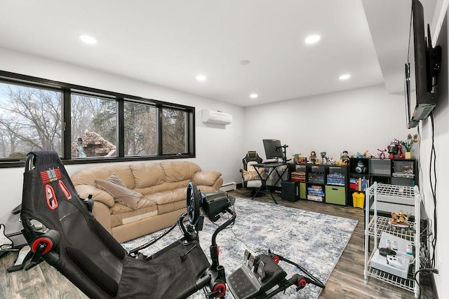 living room featuring wood-type flooring, a baseboard heating unit, and a wall mounted air conditioner