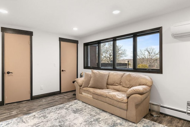 living room with baseboard heating, hardwood / wood-style floors, and a wall mounted air conditioner