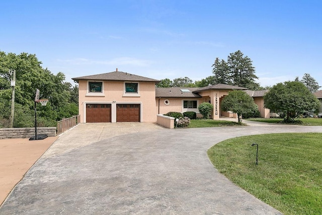 view of front of house with a front yard and a garage