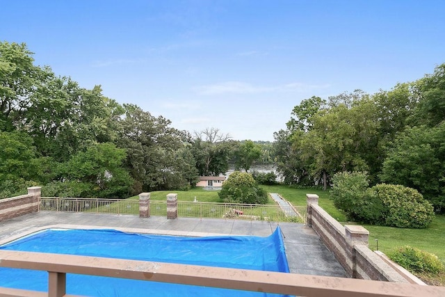 view of swimming pool featuring a lawn and a patio area