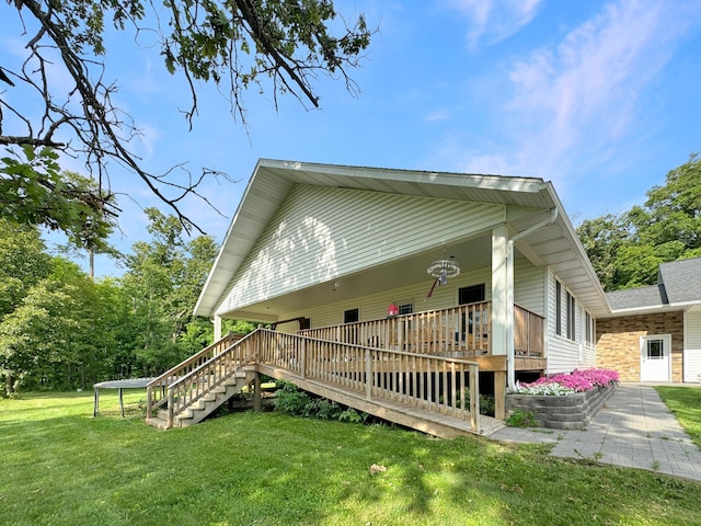 view of home's exterior with a yard, a patio, and a wooden deck