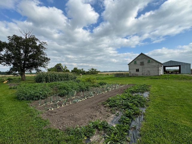 view of yard with a rural view and an outdoor structure