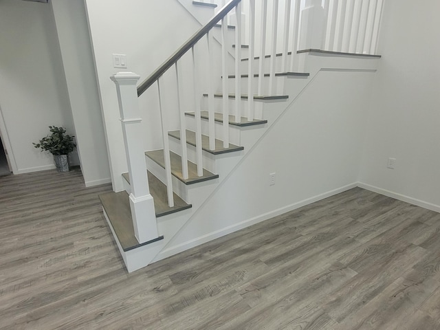 stairs with hardwood / wood-style flooring