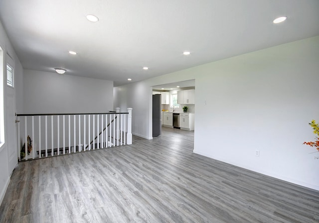 spare room featuring sink and light hardwood / wood-style flooring