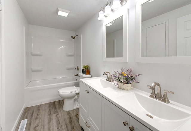 full bathroom featuring toilet, vanity, hardwood / wood-style flooring, and bathing tub / shower combination