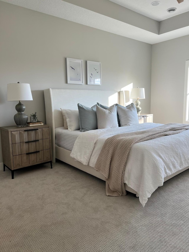 bedroom featuring light carpet and visible vents