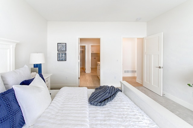 bedroom featuring baseboards and visible vents