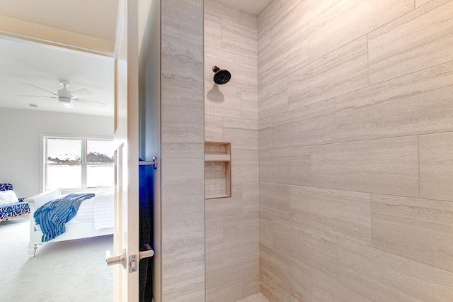 bathroom with a tile shower and ceiling fan