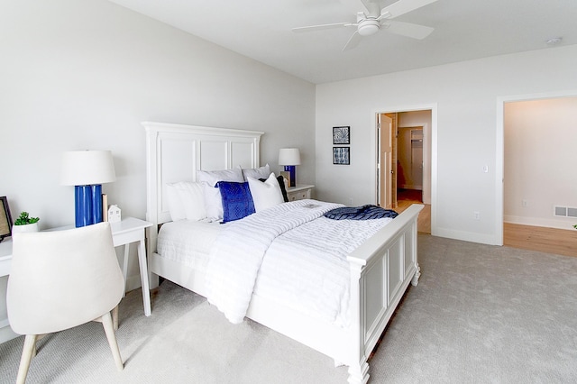 bedroom with light carpet, visible vents, a ceiling fan, and baseboards