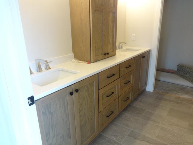 bathroom with a sink and double vanity