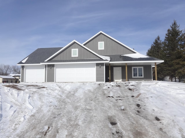 view of front facade with an attached garage and a shingled roof