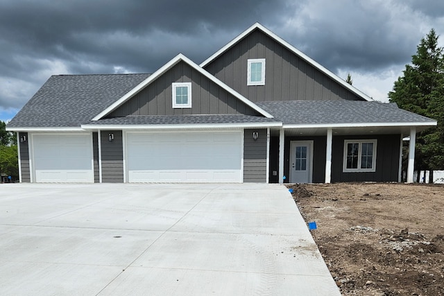 981 White Spruce Ln NW, Alexandria, MN 56308 - view of front facade with a garage, driveway, a shingled roof, a porch, and board and batten siding