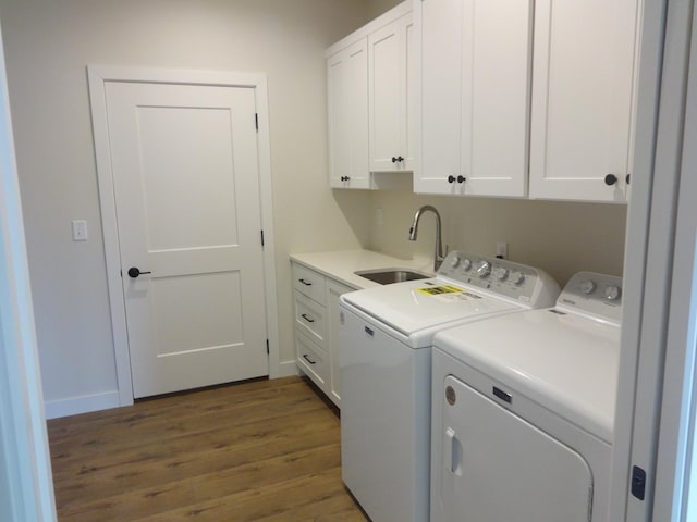 981 White Spruce Ln NW, Alexandria, MN 56308 - washroom featuring cabinet space, separate washer and dryer, and wood finished floors