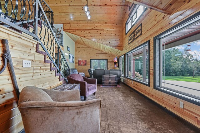 living room with high vaulted ceiling, wooden walls, and wooden ceiling