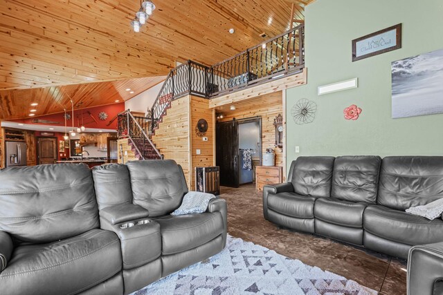 living room with wood ceiling and high vaulted ceiling