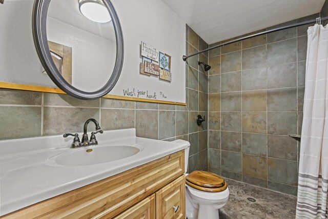 bathroom featuring tile walls, vanity, a shower with curtain, and toilet