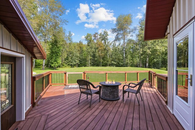 wooden terrace featuring a fire pit